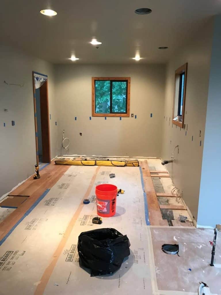 Electrical and plumbing has all been adjusted for the new layout, drywall repairs are complete, paint has been applied and the cabinets are ready to be installed.