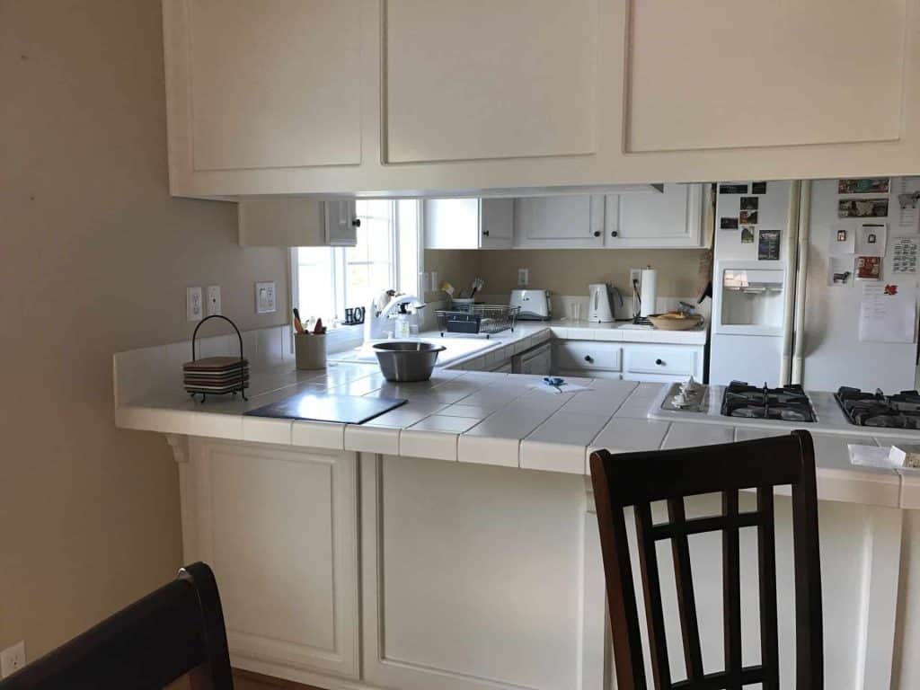 The original white cabinets were still in good shape, but the white tile countertops did not provide the color contrast and visual interest that the homeowner wanted.