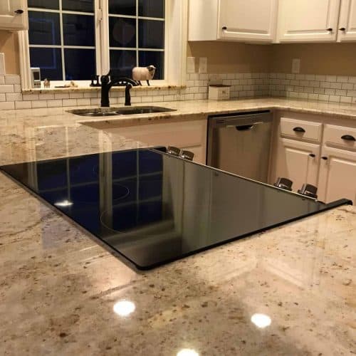 The new granite blends all the colors of the room together while maintaining the overall feeling of “light and bright”. By choosing a granite with a little “pop” of dark coloring, the dark fixtures tie into the remodel nicely.