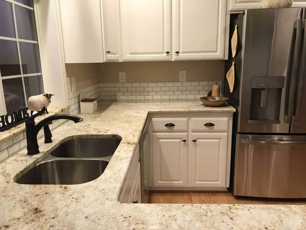 A solid surface countertop allows for an undermount sink! With all new stainless appliances, a stainless undermount was chosen.