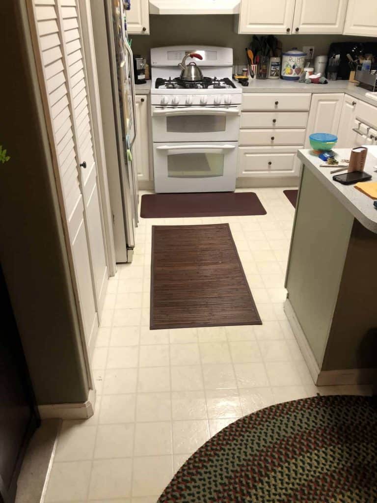 The original vinyl flooring had multiple tears and areas of discoloration.