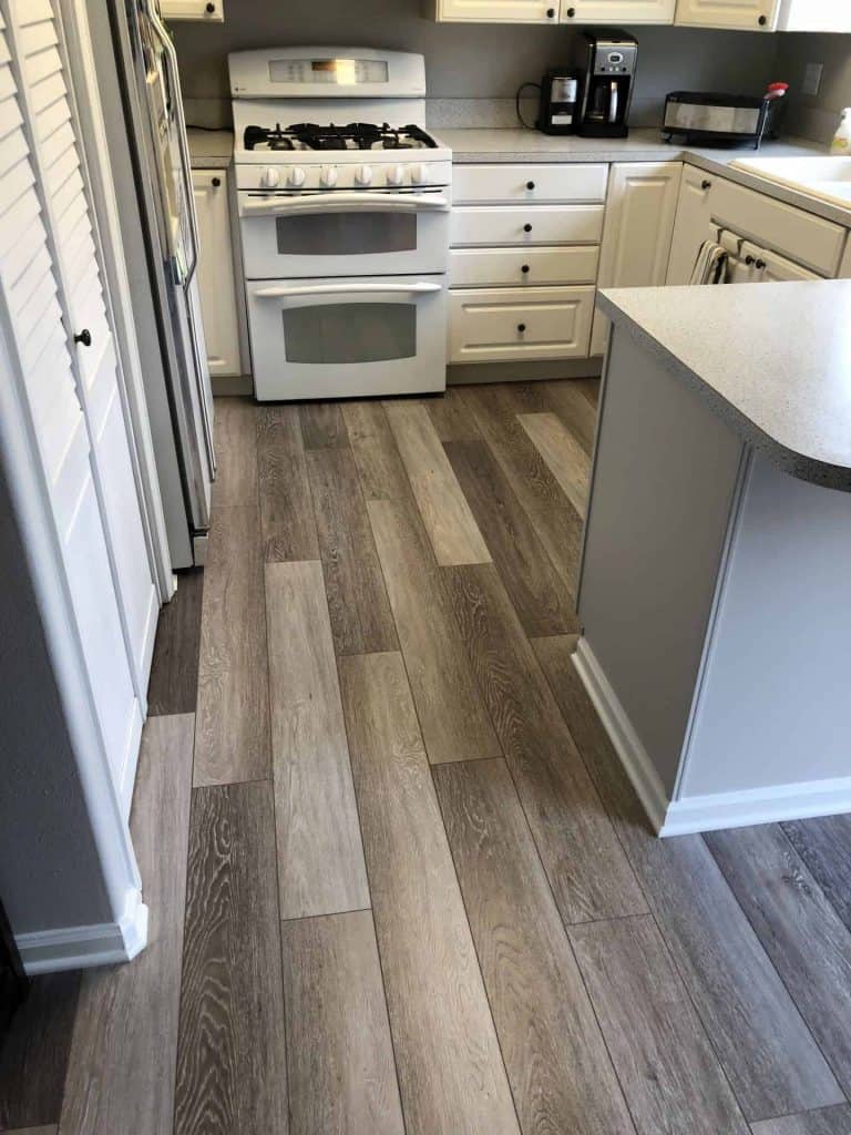 The new laminate flooring updated the home and made the kitchen cabinets look like new again.