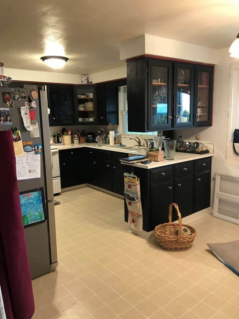The original peninsula divided the room in two, and the vinyl flooring with rubber cove base needed an upgrade. Believe it or not, all the cabinets had been hand painted with chalk board paint by the previous owner.
