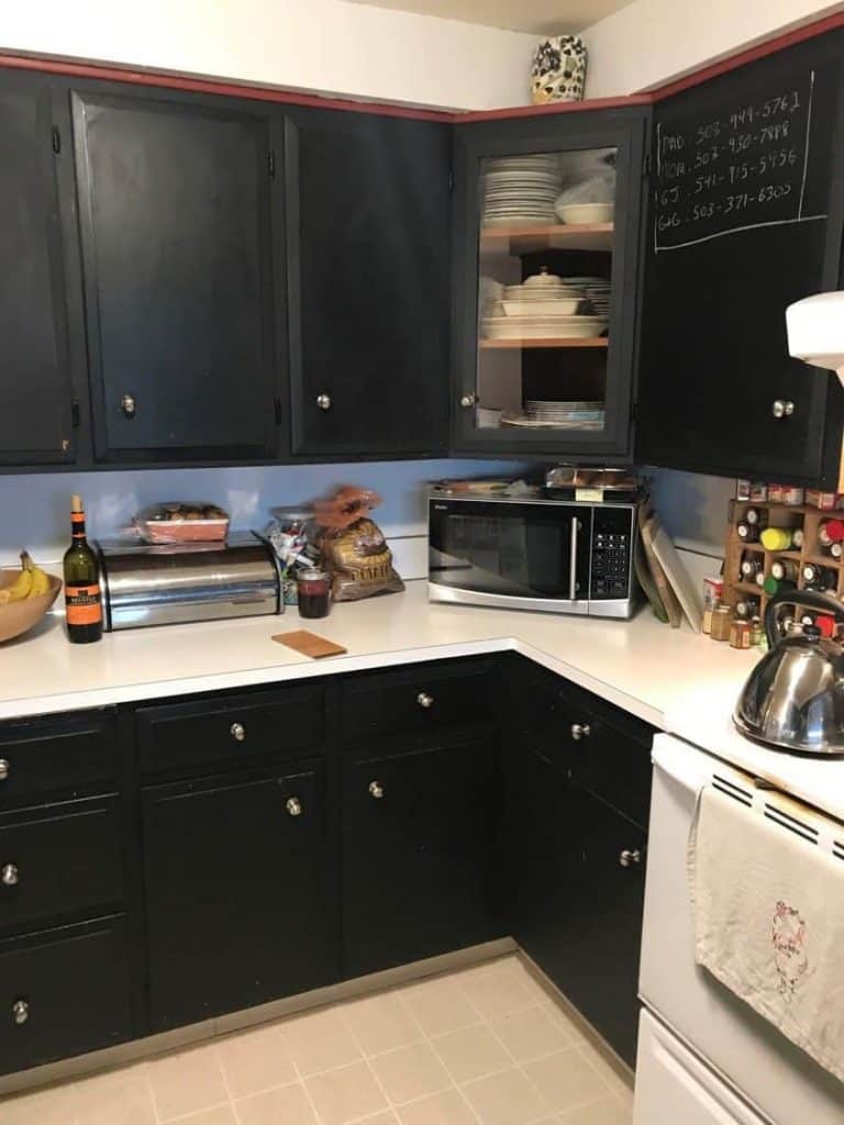 This cluttered corner needed some work. Notice how the upper cabinet was angled and the lower cabinet sat at 90 degrees. The streaks and inconsistency in the chalkboard paint were apparent, and the glass door was a bit out of place.