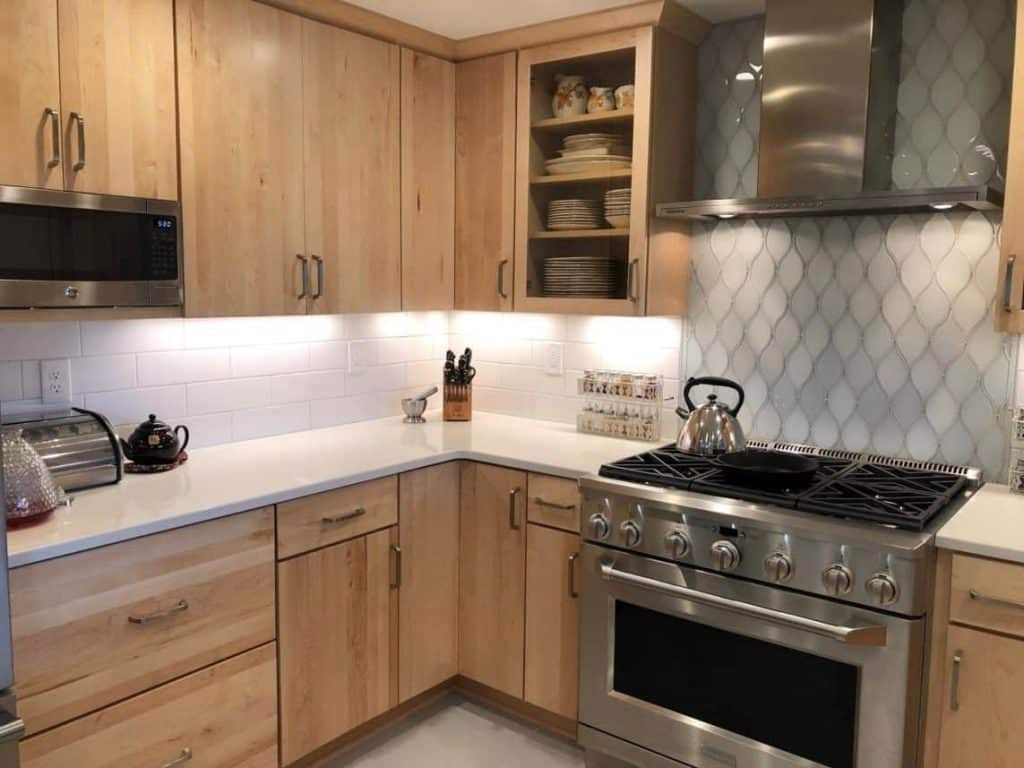 By eliminating the countertop microwave, the homeowner can utilize precious work space. Mounted beneath an upper cabinet, the “space-saver” microwave is a great solution for this kitchen.