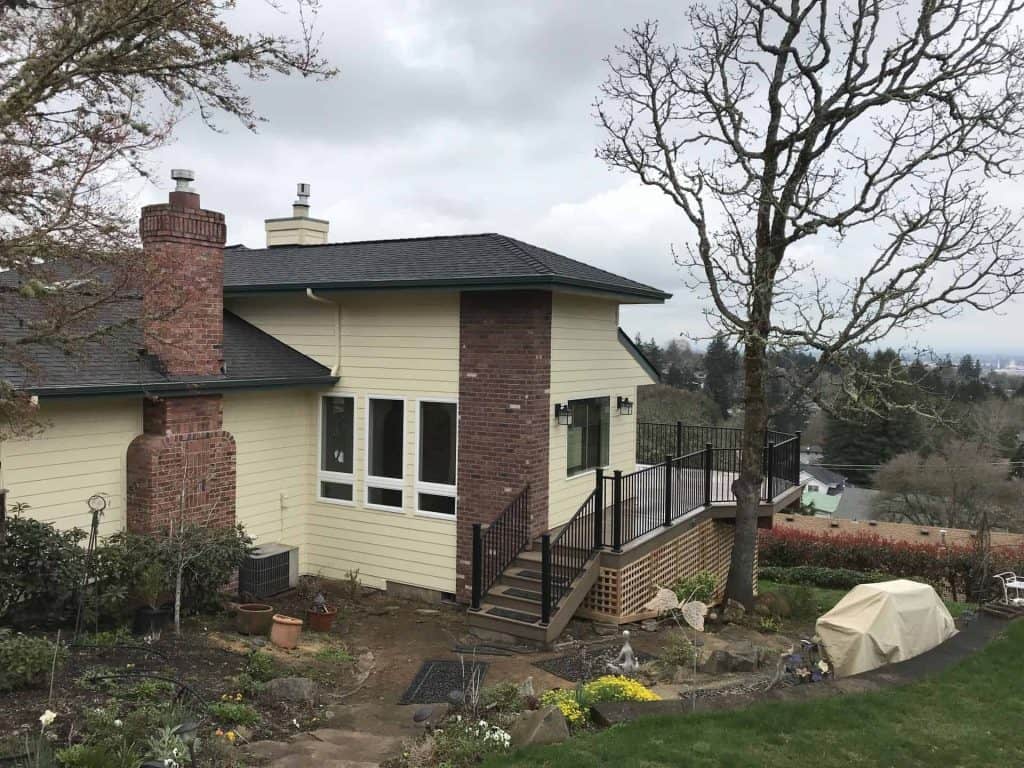Exterior painting is applied to match the rest of the home and the new composite deck and metal railing are complete. This family is ready to host the next Holiday!