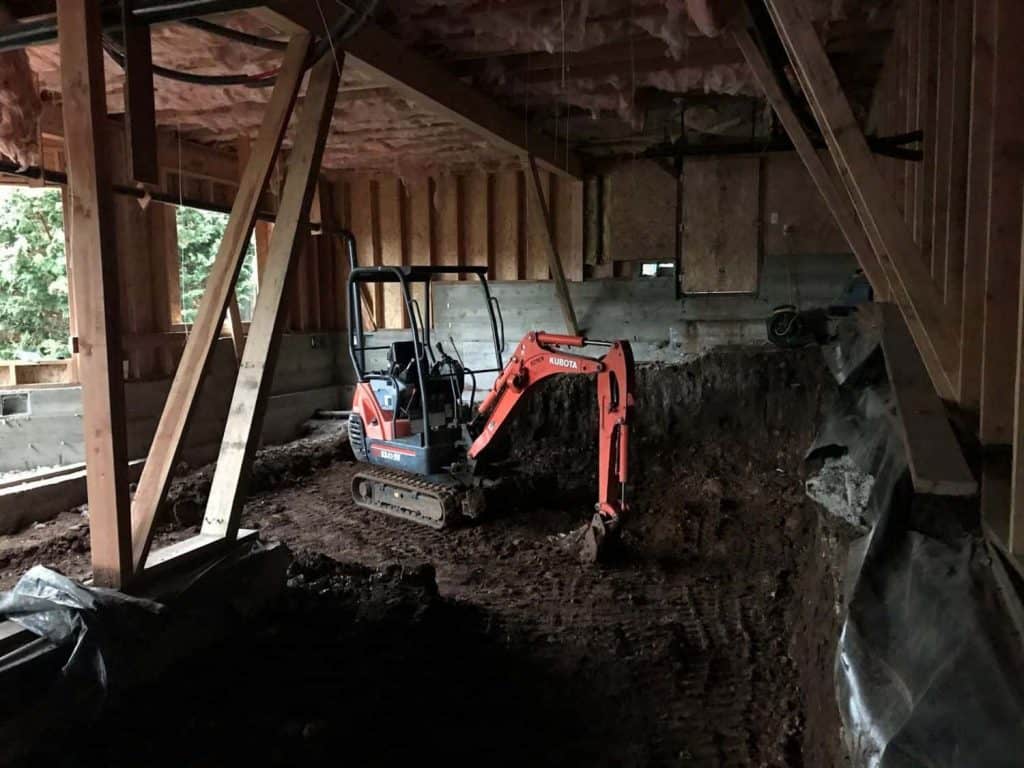 In order to prepare the land for a 1300 square foot addition, we had to start with the proper dig out. We needed enough space under the existing home to create the desired 9 ft ceiling height.