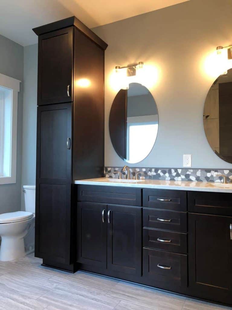 The master bathroom is complete with tile floors, linen cabinet, and a double vanity to match the cabinets in the rest of the home.