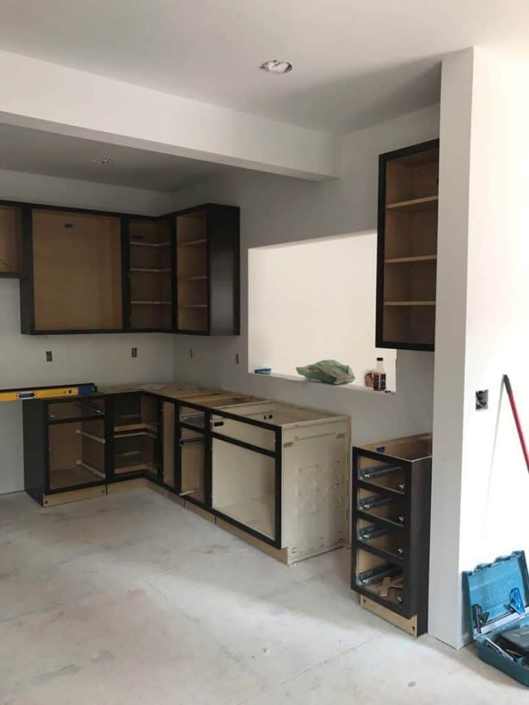With the drywall complete, it is time to set the new cabinets and see the kitchen come to life. The composite Coreguard sink base is specifically designed to handle any leaks or spills that may occur under the sink.