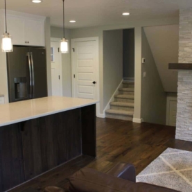 AFTER We removed the wall to open the space, and everything you see is brand new… split face marble stack stone, new cabinetry, lighting, hickory floors, new carpet, quartz countertops, and more….