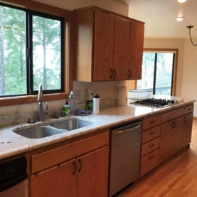 BEFORE It was time for an update in this kitchen. The homeowner dreamed of dark grey cabinets and modern fixtures while preserving the golden oak floors and trim work throughout the entire home