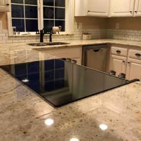 AFTER The new granite blends all the colors of the room together while maintaining the overall feeling of “light and bright”. By choosing a granite with a little “pop” of dark coloring, the dark fixtures tie into the remodel nicely.