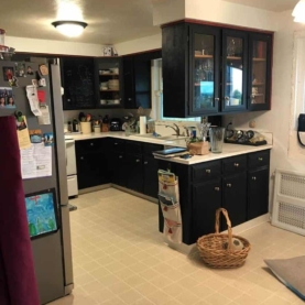 BEFORE The original peninsula divided the room in two, and the vinyl flooring with rubber cove base needed an upgrade. Believe it or not, all the cabinets had been hand painted with chalk board paint by the previous owner.