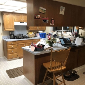 BEFORE Your original kitchen consists of outdated cabinets, a drop ceiling with fluorescent lighting, and a long peninsula with upper cabinets.