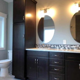 AFTER The master bathroom is complete with tile floors, linen cabinet, and a double vanity to match the cabinets in the rest of the home.