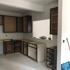 DURING With the drywall complete, it is time to set the new cabinets and see the kitchen come to life. The composite Coreguard sink base is specifically designed to handle any leaks or spills that may occur under the sink.